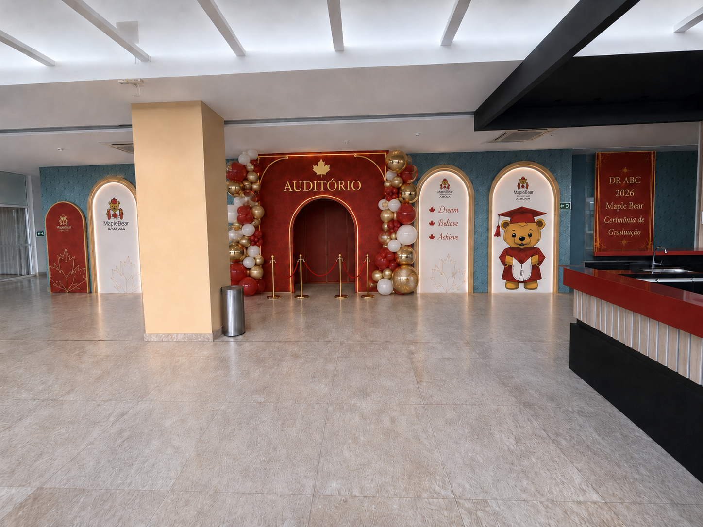 Entrada do auditório com pórtico vermelho, arcos laterais e balões